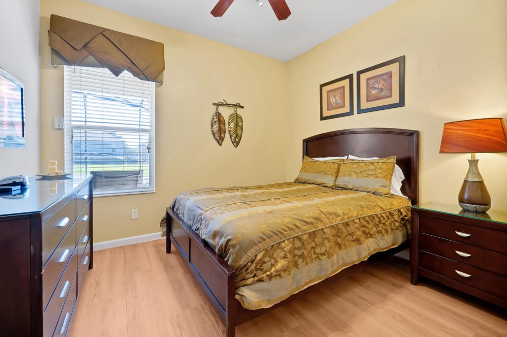 Cozy bedroom with elegant decor and natural light from a large window.