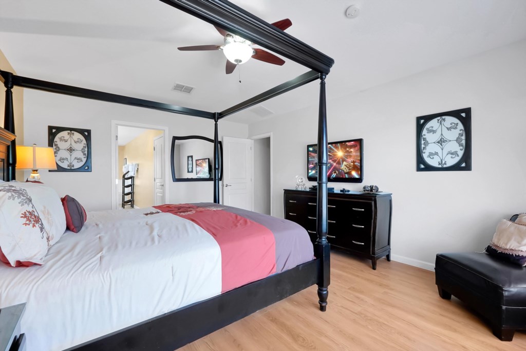 Elegant bedroom with a four-poster bed and modern decor.
