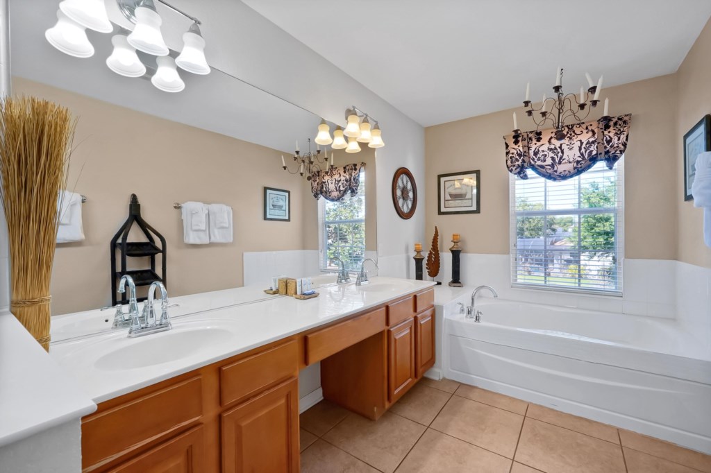 Elegant bathroom with double sinks and a relaxing soaking tub.