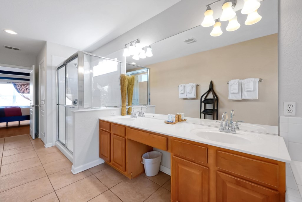 Spacious bathroom with dual sinks and a walk-in shower for your comfort.