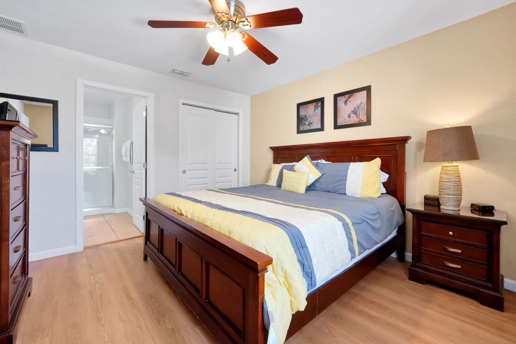Cozy bedroom with ensuite bathroom and elegant wooden furniture.