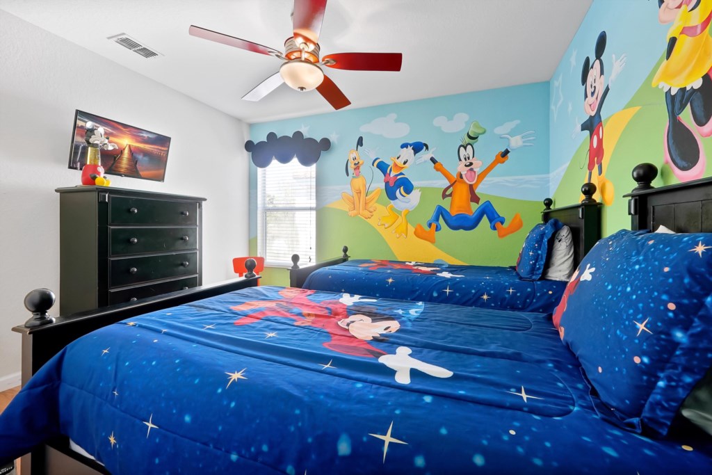 Vibrant kids' room with themed decor and twin beds perfect for a magical stay.