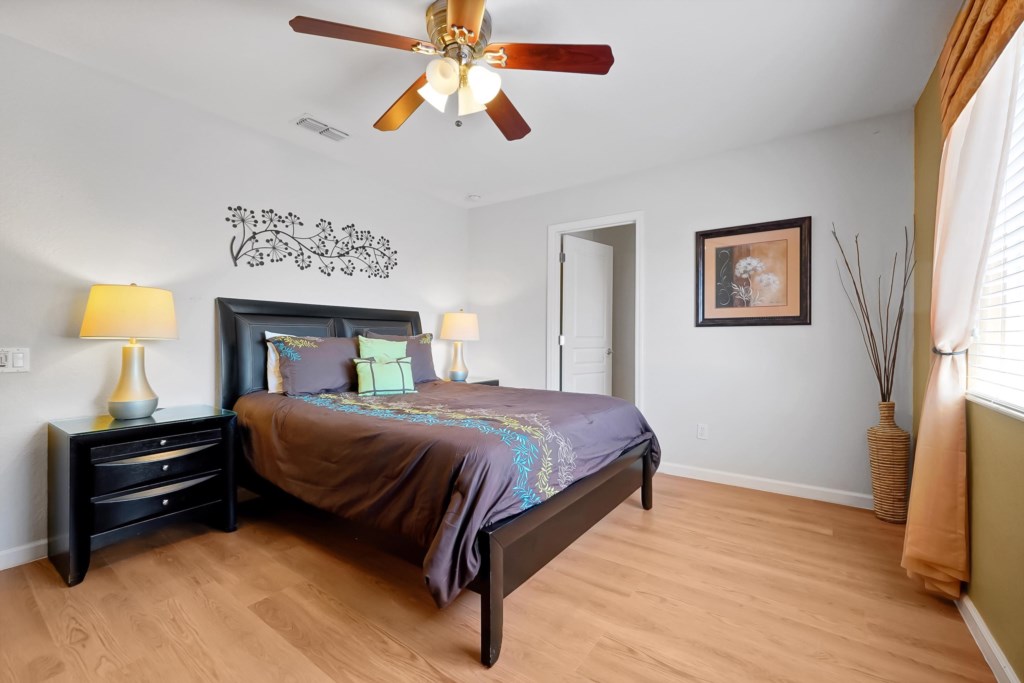 Cozy bedroom with elegant decor and natural light, perfect for a restful night's sleep.