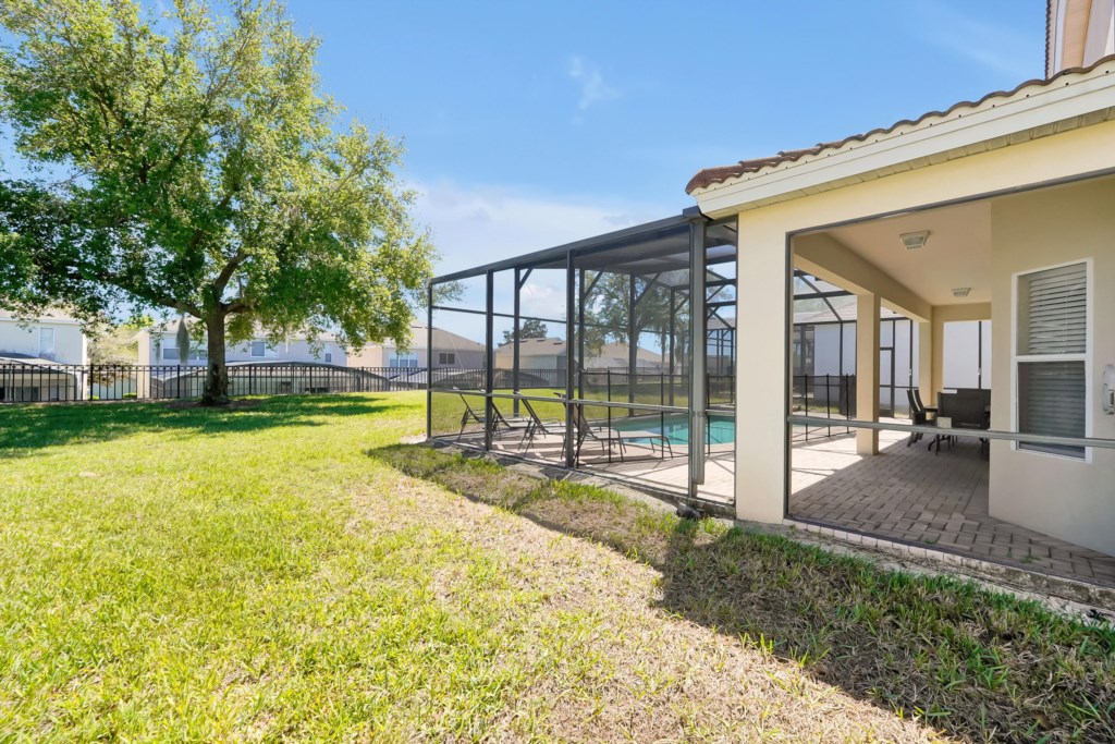 Screened patio with pool and seating, perfect for outdoor relaxation.