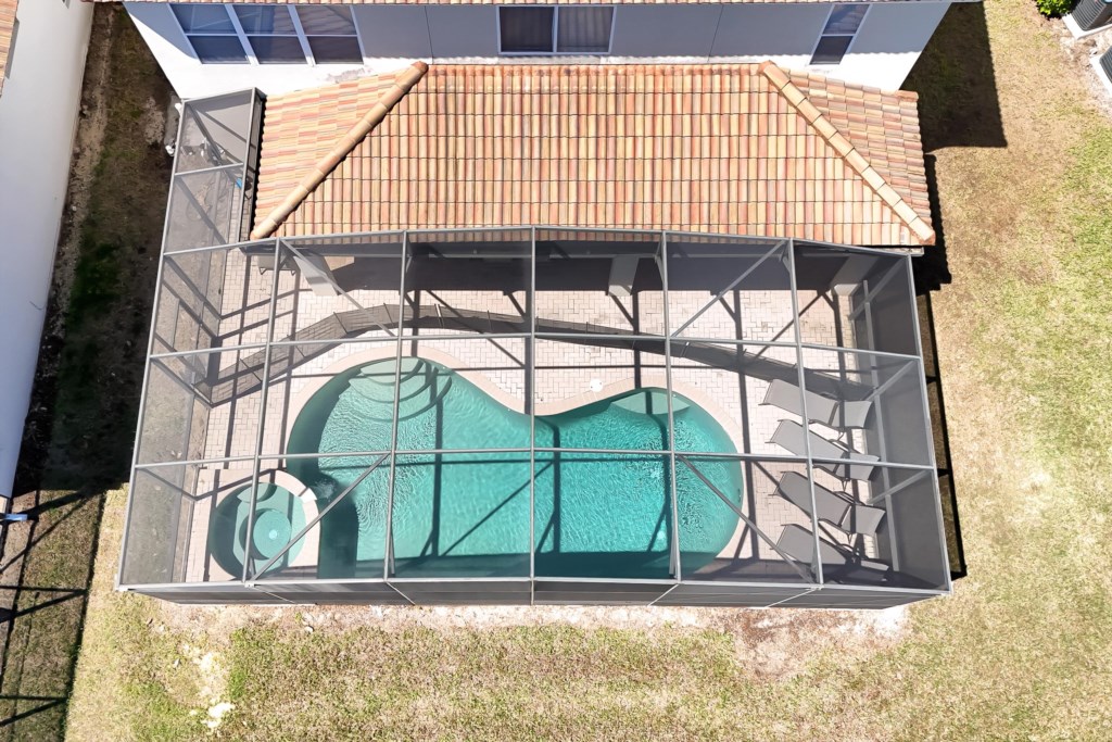 Private screened-in pool and spa area, perfect for relaxation and sunbathing.