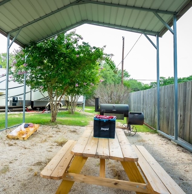Corn hole and communal barbeque pit.