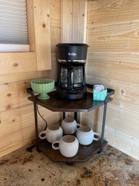 Four cup drip coffee pot and coffee, creamer & sugar provided.