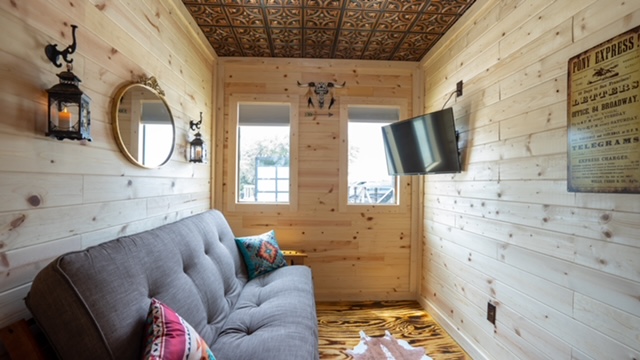 Living space offers natural light.   Welcome to the Wild West shipper cabin!