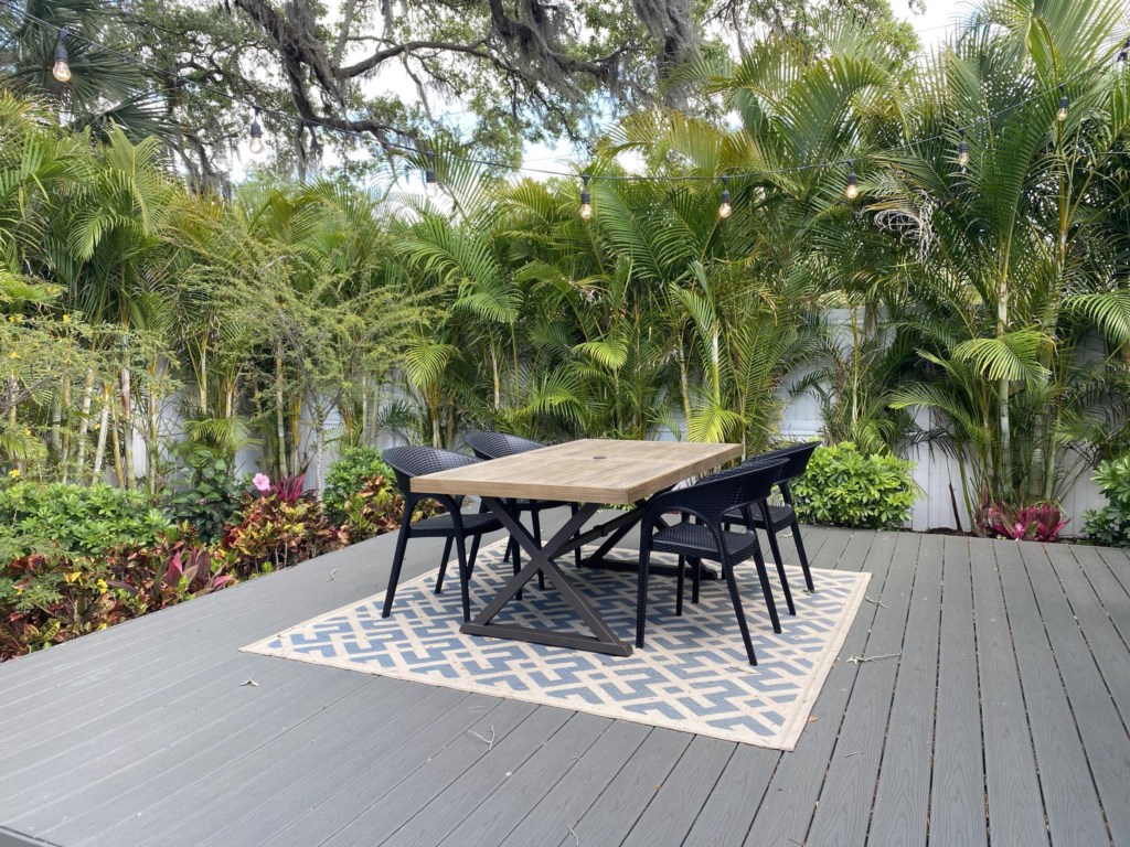 Beautiful outdoor dining space surrounded by tropical FL landscape!