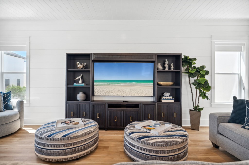 Designer furniture and large TVs compliment the home