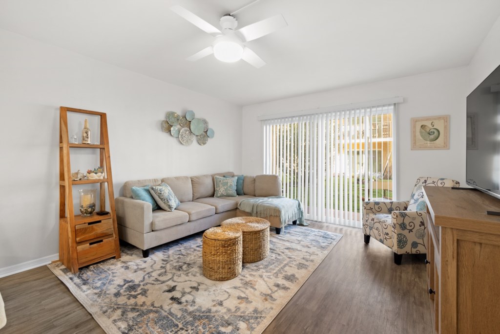 Bright living room opening onto a patio, ideal for indoor-outdoor relaxation.