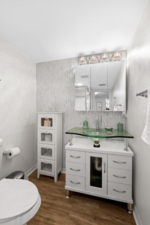 Modern bathroom with chic glass sink and stylish tile backsplash.