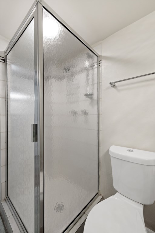 Sleek bathroom with glass shower enclosure and modern fixtures.