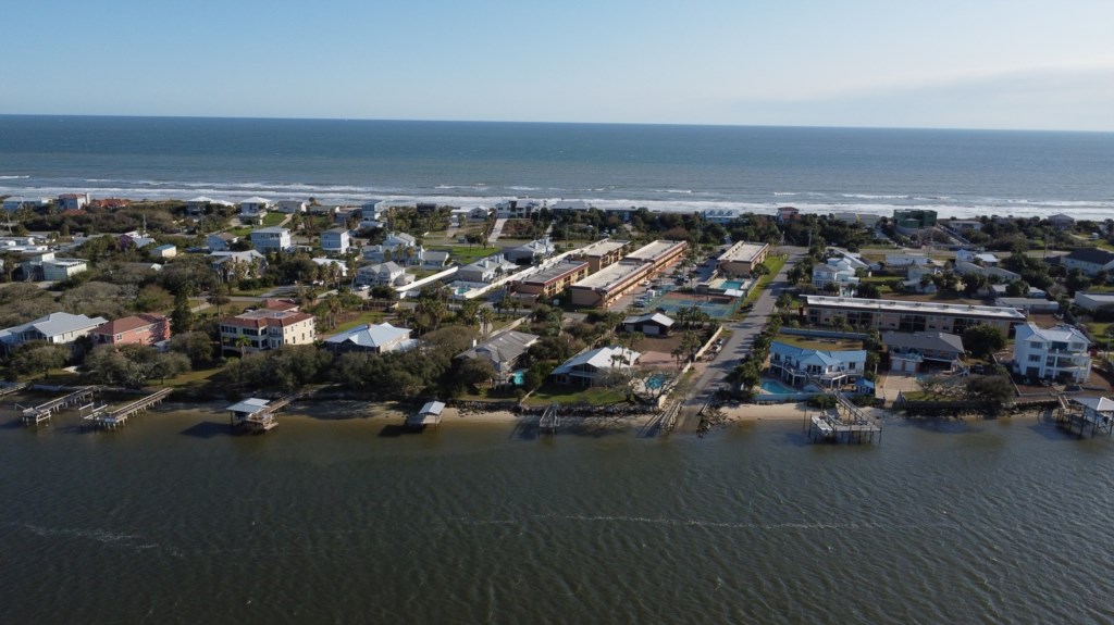 Aerial view of a charming coastal village, perfect for a serene getaway.
