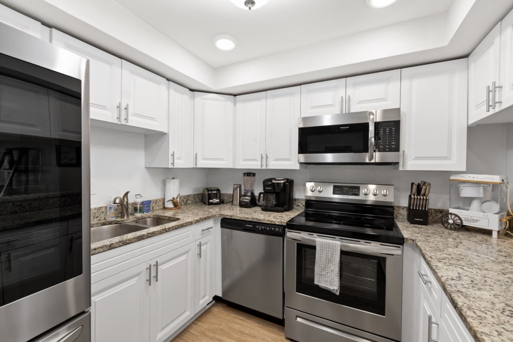 Modern kitchen with stainless steel appliances and spacious countertops.
