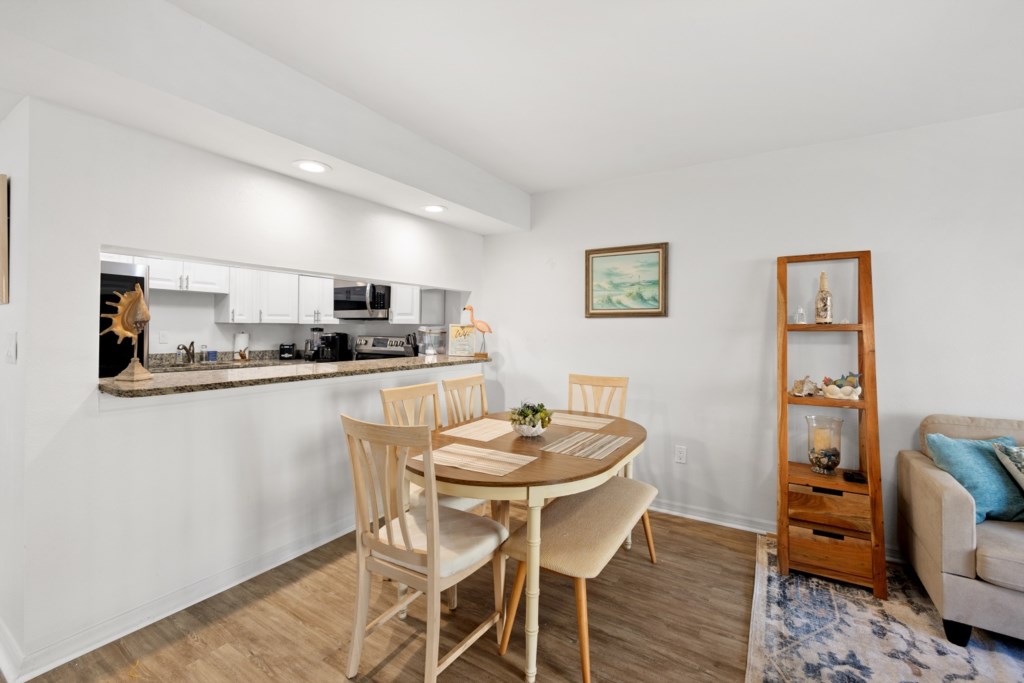Bright dining space adjacent to a modern kitchen, ideal for home-cooked meals.