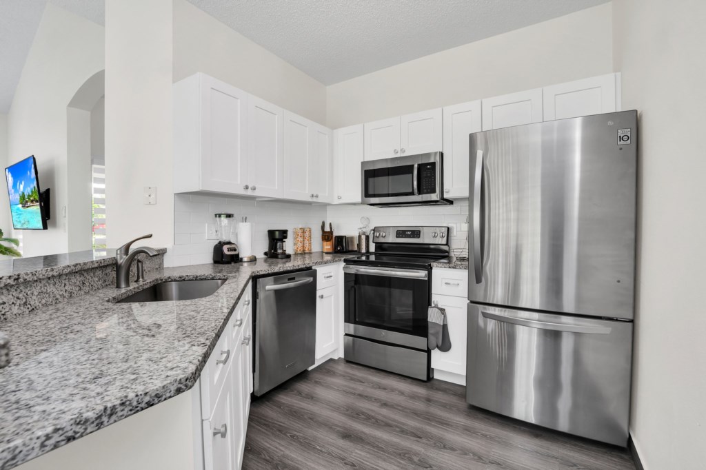Upgraded kitchen with clean crisp look and open to dining and family room