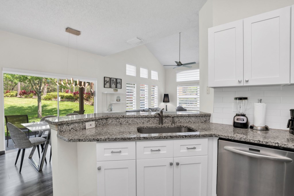 Upgraded kitchen with clean crisp look and open to dining and family room