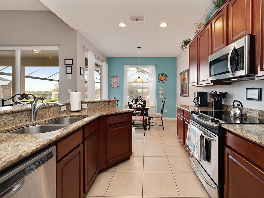 Fully equipped kitchen features granite counter tops and stainless appliances
