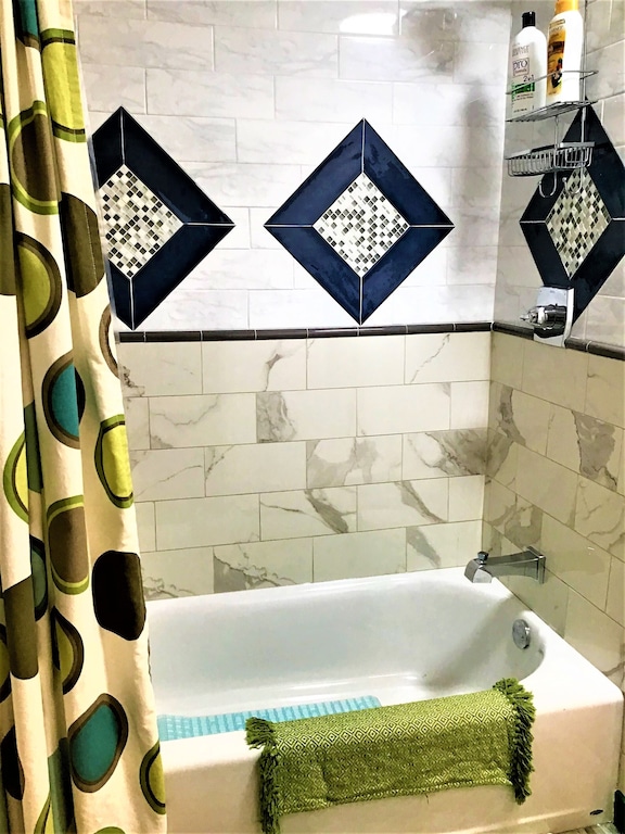 Tub and shower with features of beutiul tile work.