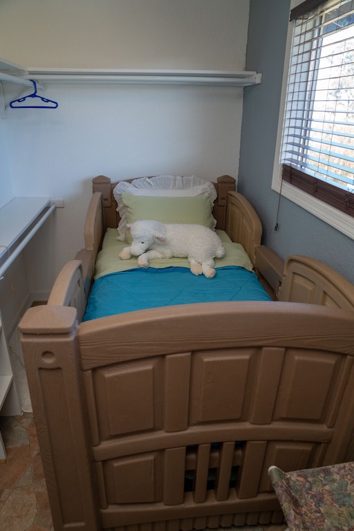 Twin Bed adjacent to primary bedroom, for a young child.