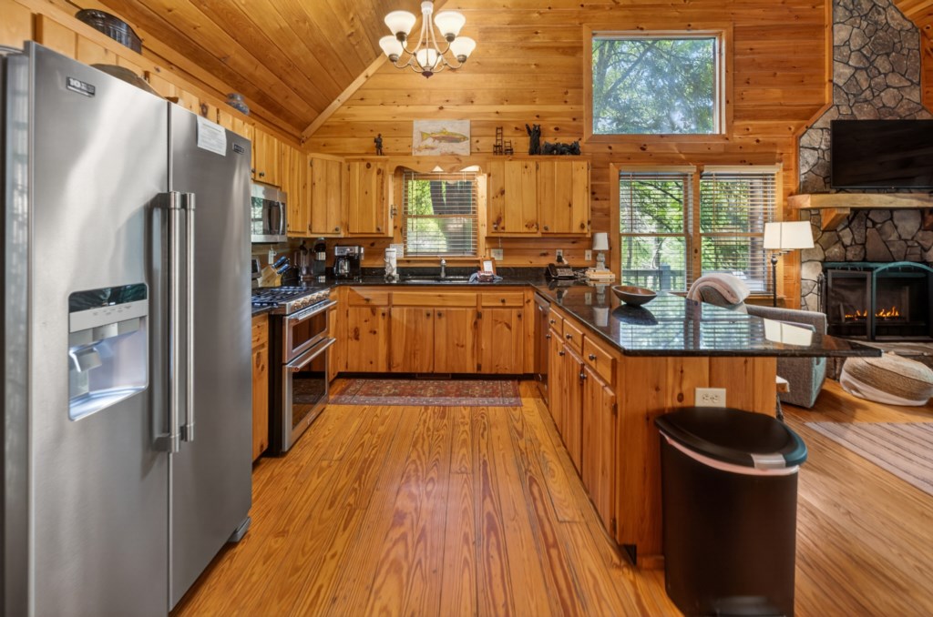 Rustic kitchen with modern appliances and cozy cabin ambiance.