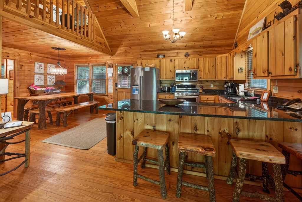 Rustic kitchen with wooden cabinetry and breakfast bar, perfect for cozy cabin meals.