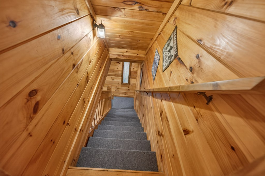 Rustic wooden stairway leading to cozy cabin rooms.