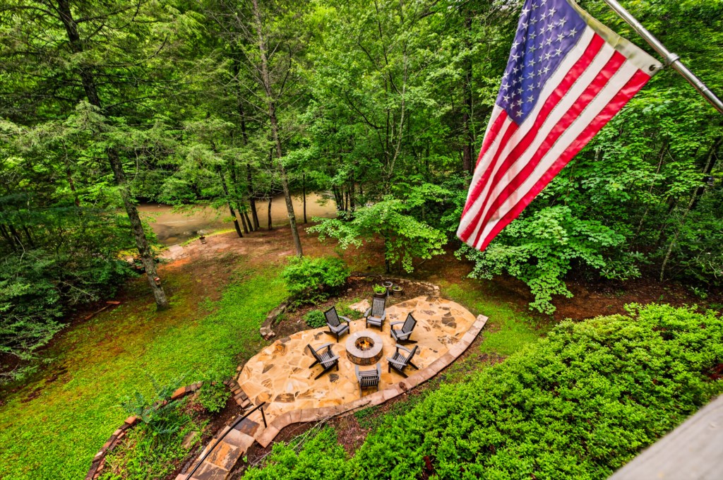 Serene outdoor firepit area surrounded by lush forest, perfect for evening gatherings.