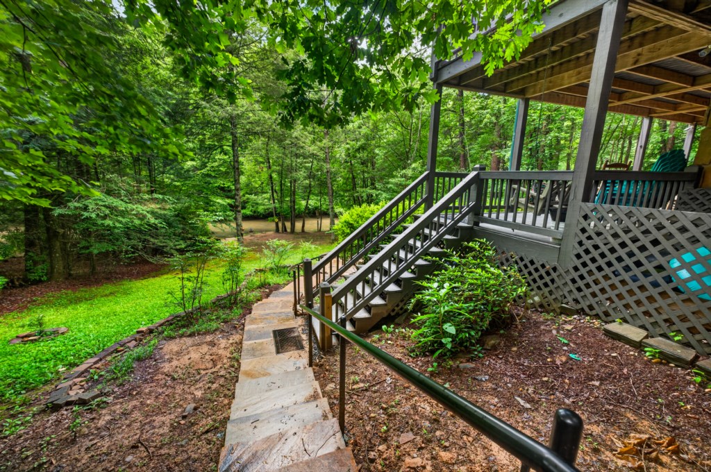 Charming deck overlooking a lush forest, perfect for peaceful mornings with nature.