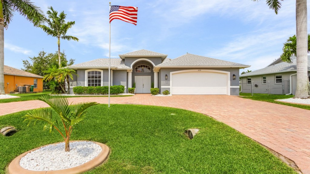 Welcoming front yard with a pristine lawn and striking home exterior.