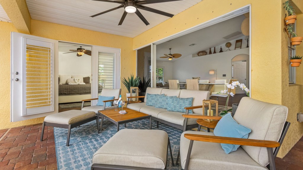 Relax in this cozy lounge area with plush seating and ceiling fan comfort.