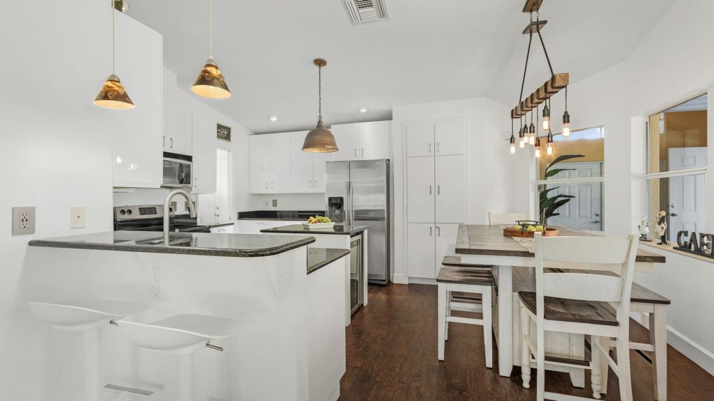 Spacious modern kitchen with sleek countertops and all the essentials for cooking.