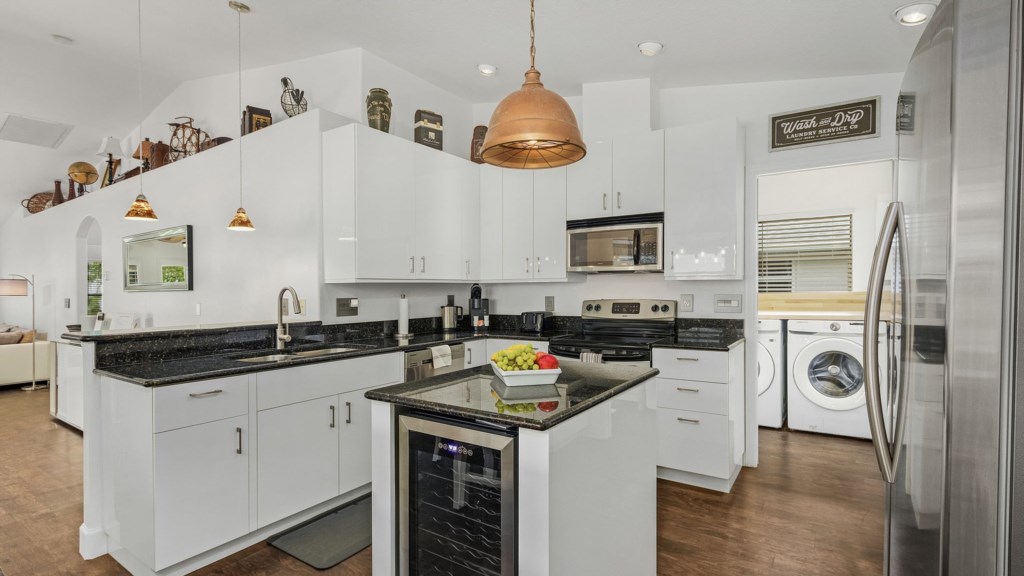 Fully equipped modern kitchen with sleek finishes and stainless-steel appliances.