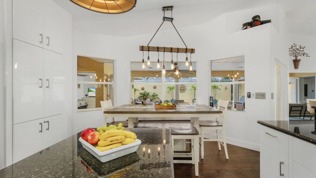 Cozy dining nook with a charming light fixture and plenty of natural light.