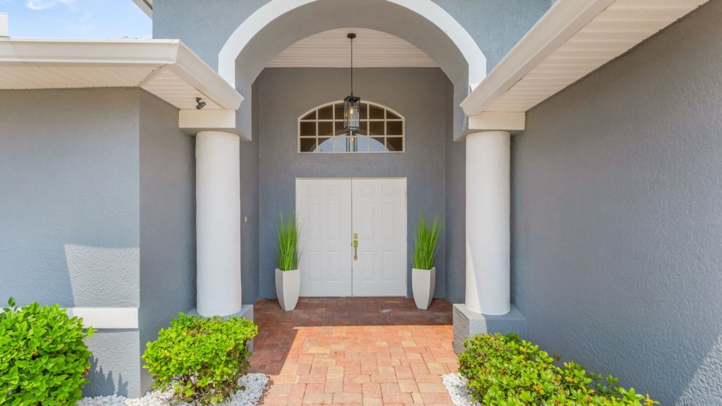 Inviting front entrance with stylish pillars and modern charm.