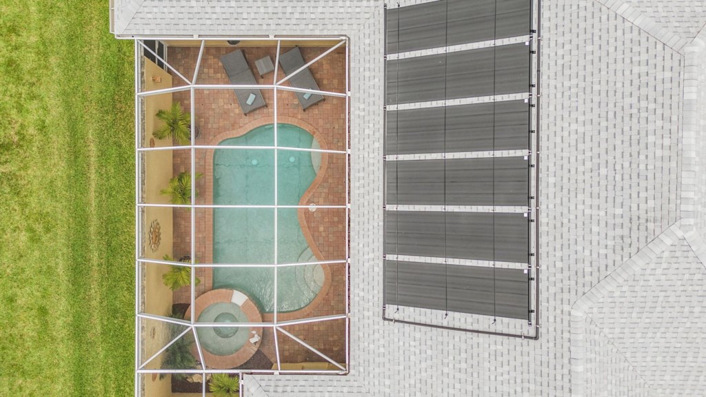 Bird’s-eye view of the private pool area with lounge chairs and a spa.