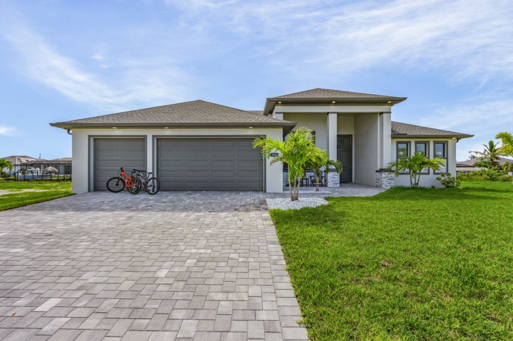 Spacious driveway and garage with room for bikes and extra storage.