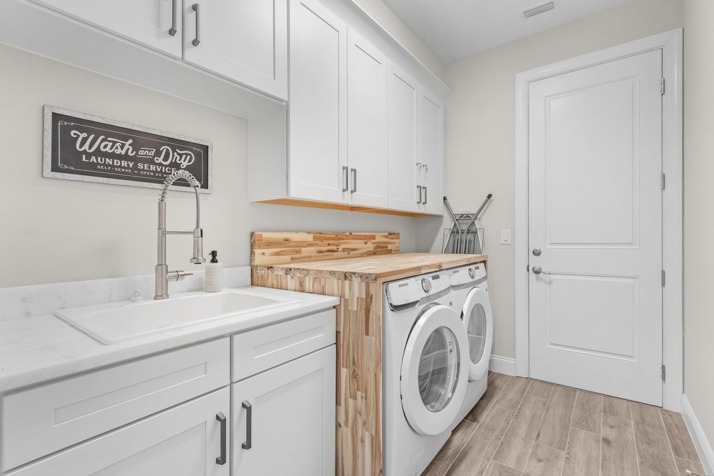 Convenient laundry room with modern appliances and ample counter space for folding