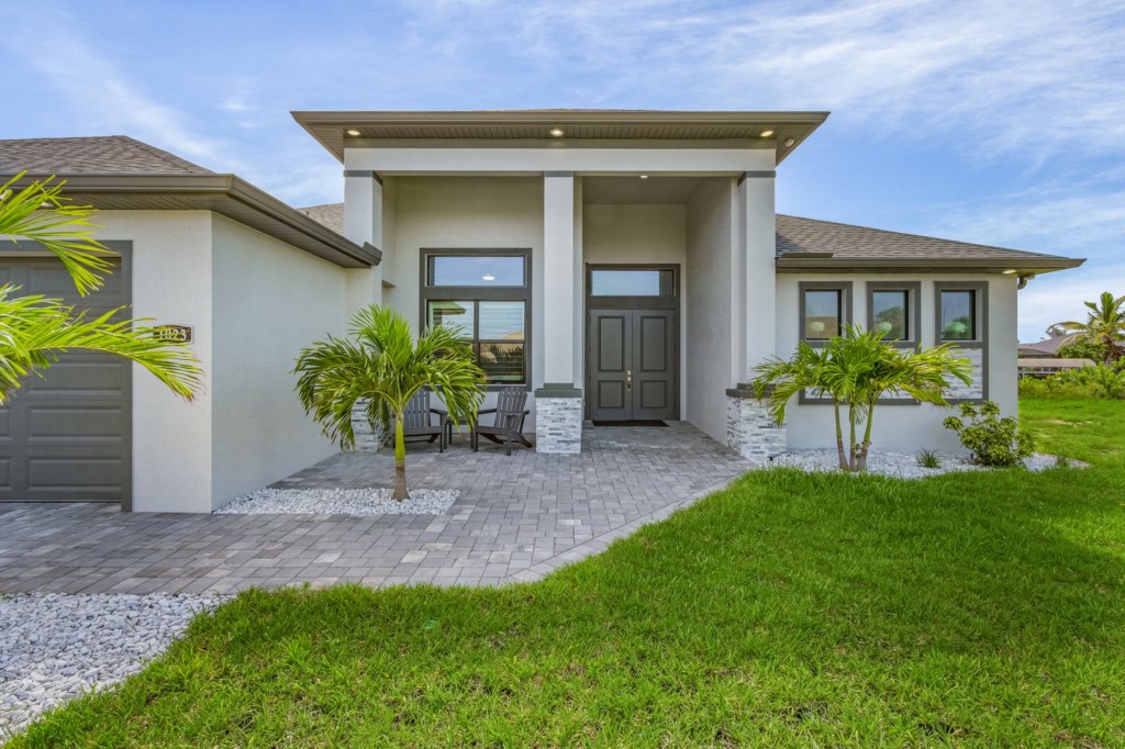 Modern entrance with clean lines and tropical landscaping, welcoming you home.