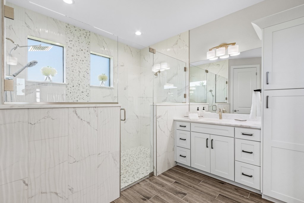 Spacious bathroom with double vanity and a sleek walk-in shower for a luxury experience.