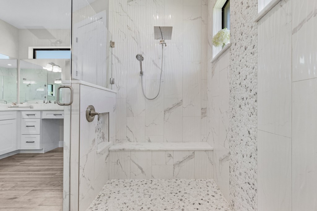 Elegant walk-in shower with a built-in bench and modern tile design for ultimate relaxation.