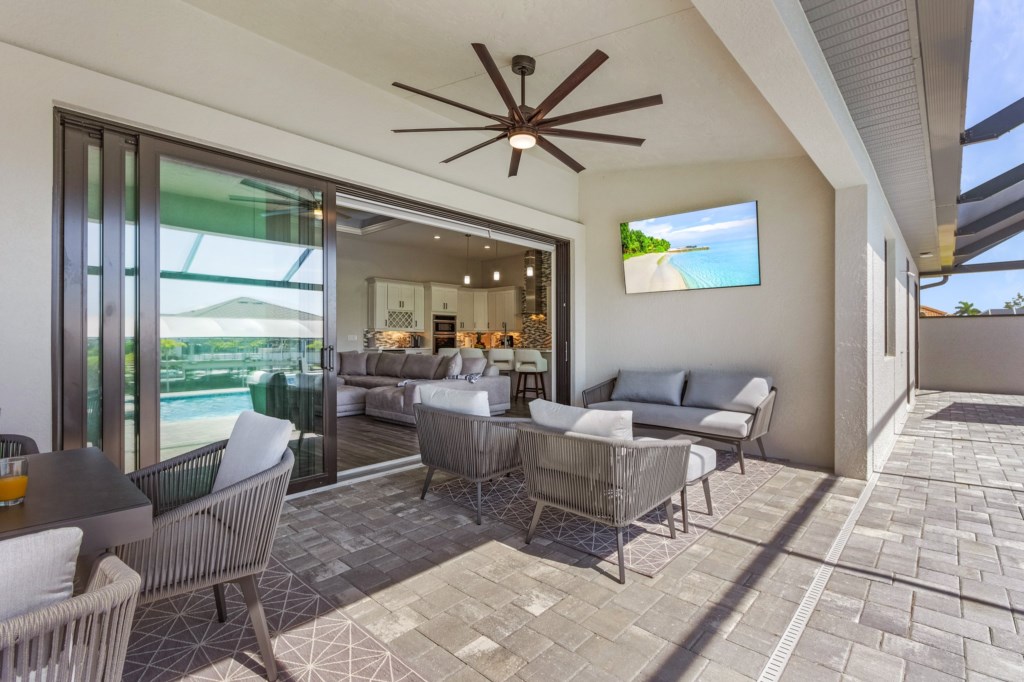 Comfortable outdoor seating area with ceiling fan, ideal for lounging and enjoying the view.