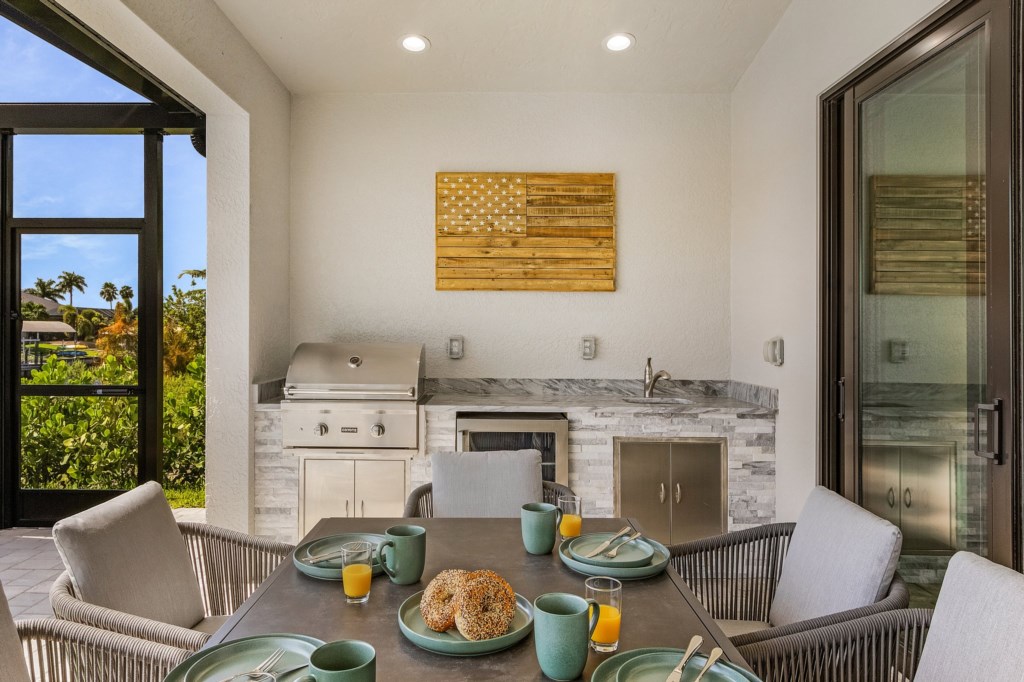 Fully equipped outdoor kitchen with a grill and prep space for convenient cooking.