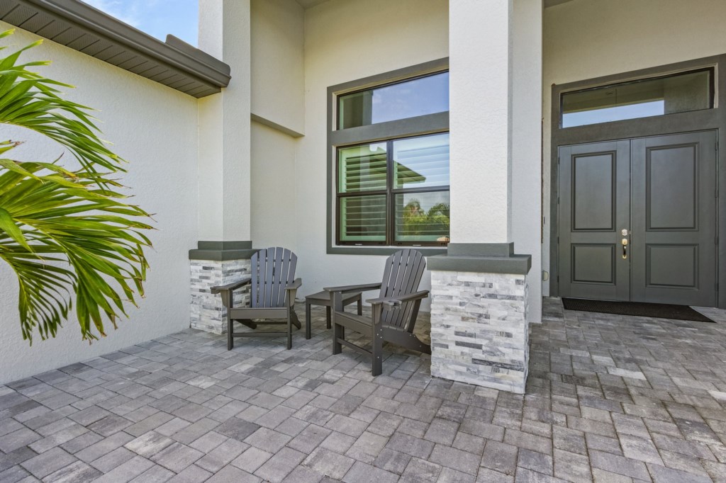 Cozy front porch seating, perfect for morning coffee or evening relaxation.