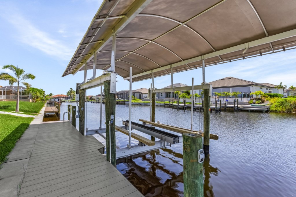 Private dock with boat lift for easy access to the canal and boating adventures.