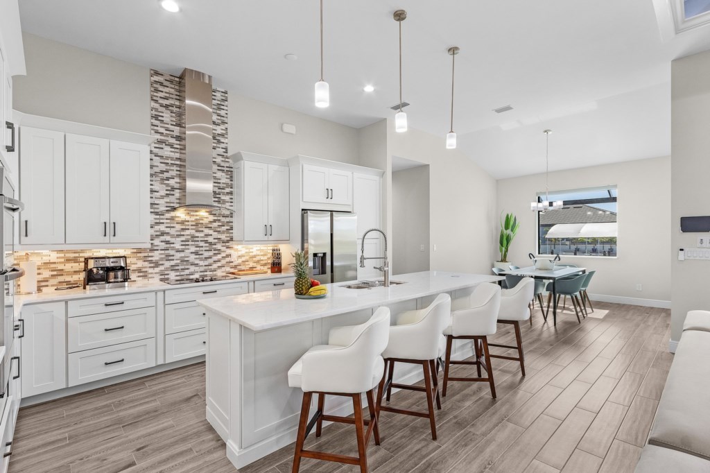 Sleek, modern kitchen with bar seating and top-of-the-line appliances for gourmet meals.