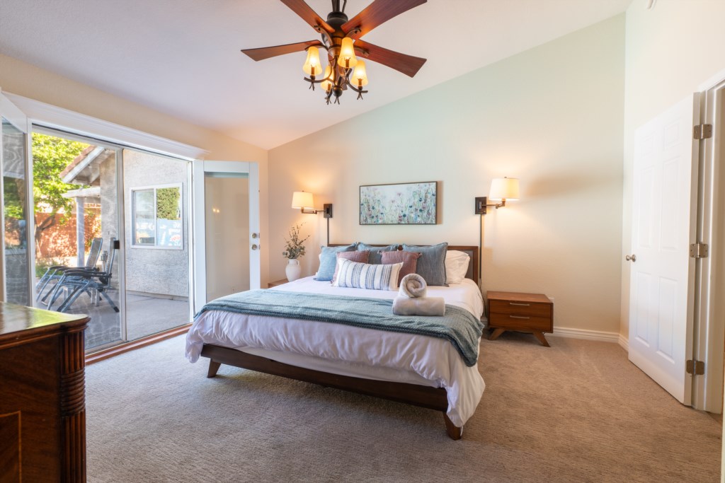 Bright bedroom with patio access and cozy decor for a relaxing stay.
