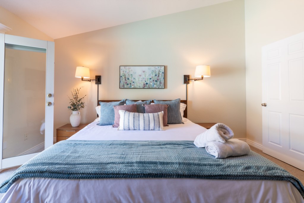 Cozy bedroom with plush pillows, soft lighting, and a welcoming atmosphere for restful nights.