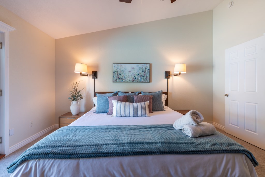 Cozy bedroom with plush bedding and soft lighting for a restful night's sleep.